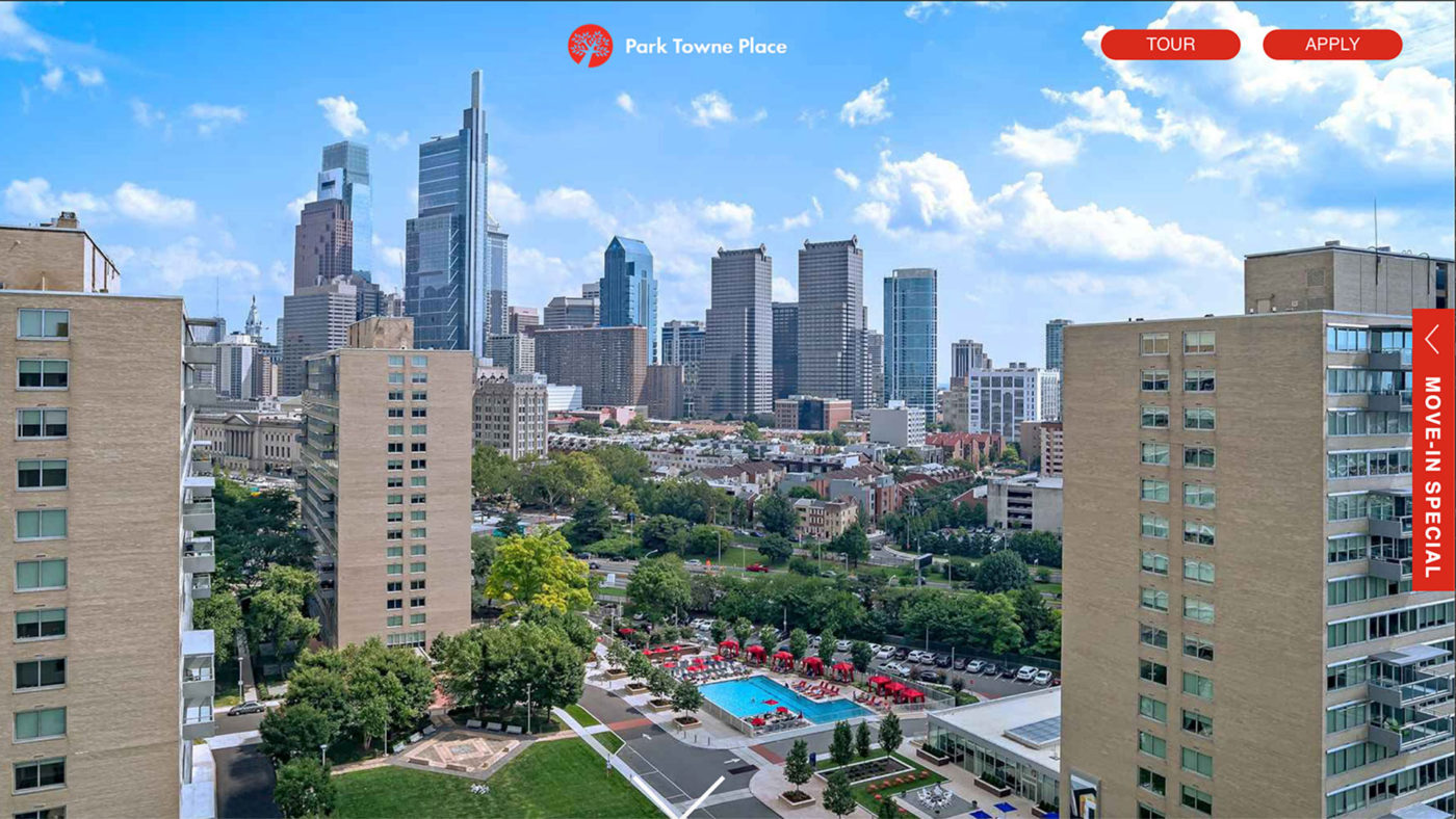 a photo of the Philadelphia skyline and the advertised apartments takes up the browser window. The apartment logo and tour and apply buttons sit in the top right corner.